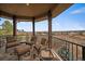 Covered porch with ample seating and stunning views of the surrounding landscape at 1159 Buffalo Ridge Rd, Castle Pines, CO 80108