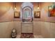 Charming powder room with an arched window and neutral decor at 1159 Buffalo Ridge Rd, Castle Pines, CO 80108