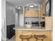 Studio apartment kitchen with light wood cabinets and stainless steel appliances at 1196 N Grant St # 204, Denver, CO 80203