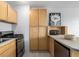 Modern kitchen with stainless steel appliances and light wood cabinets at 1196 N Grant St # 204, Denver, CO 80203