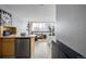 Studio apartment kitchen with light wood cabinets, stainless steel appliances, and a breakfast bar at 1196 N Grant St # 204, Denver, CO 80203