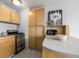 Studio apartment kitchen with light wood cabinets and stainless steel appliances at 1196 N Grant St # 204, Denver, CO 80203