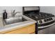 Stainless steel sink and gas range in updated kitchen at 1196 N Grant St # 204, Denver, CO 80203