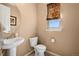 Cozy bathroom featuring neutral colors, pedestal sink, and decorative window treatment at 23584 E 5Th Pl, Aurora, CO 80018