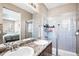 Bright bathroom featuring double sinks, granite countertop, shower, and tiled floor at 23584 E 5Th Pl, Aurora, CO 80018