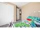 This bedroom includes a closet, neutral walls, and carpeted floor, along with a colorful bedspread at 23584 E 5Th Pl, Aurora, CO 80018