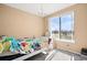 Cozy bedroom with natural light, decorated with bright floral bedding and chandelier at 23584 E 5Th Pl, Aurora, CO 80018