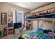 Bedroom featuring bunkbeds, shelves, a window, and a TV with a comfortable, carpeted floor at 23584 E 5Th Pl, Aurora, CO 80018
