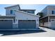 Exterior view of a well-maintained home showcasing gray siding, dark garage doors, and modern design at 23584 E 5Th Pl, Aurora, CO 80018