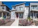 Charming gray two-story home featuring stone accents and a red front door at 23584 E 5Th Pl, Aurora, CO 80018