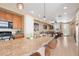 Open floorplan showing a spacious kitchen overlooking a living area with wood floors at 23584 E 5Th Pl, Aurora, CO 80018