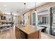 Open floor plan showing a kitchen island with a view to the living area and patio at 23584 E 5Th Pl, Aurora, CO 80018