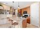 A functional kitchen featuring wood cabinets and an island with bar stool seating at 23584 E 5Th Pl, Aurora, CO 80018