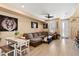 Spacious living room featuring a large sectional couch and light wood floors at 23584 E 5Th Pl, Aurora, CO 80018