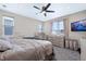 This bedroom includes a ceiling fan, carpeted floor, and a crib at 23584 E 5Th Pl, Aurora, CO 80018