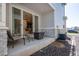 Back patio with sliding door, stone detail, seating, and an air conditioning unit at 23584 E 5Th Pl, Aurora, CO 80018