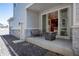 Cozy patio with stone detail, a sliding glass door, and seating with a view of the yard at 23584 E 5Th Pl, Aurora, CO 80018