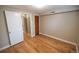 Finished basement featuring hardwood floors, door, and base trim at 2592 S Winona Ct, Denver, CO 80219