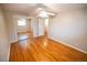 Sunlit bedroom boasts hardwood floors and mirrored closet doors at 2592 S Winona Ct, Denver, CO 80219