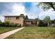 Beautifully kept home with a green lawn, walkway, and charming covered porch, exuding curb appeal at 2592 S Winona Ct, Denver, CO 80219