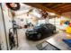Functional garage interior with a car, ladder, overhead lighting, and ample storage space at 2592 S Winona Ct, Denver, CO 80219