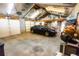 Spacious garage interior with natural light, storage, and a black car parked inside at 2592 S Winona Ct, Denver, CO 80219