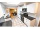 Modern kitchen with white cabinets, granite countertops, and stainless steel appliances at 2592 S Winona Ct, Denver, CO 80219