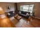 Bright living room featuring a wood-burning stove, wood floors, and neutral decor at 2592 S Winona Ct, Denver, CO 80219