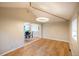 Bright living room featuring hardwood floors and modern light fixture at 2592 S Winona Ct, Denver, CO 80219