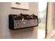 Fender guitar amp keychain holder mounted on a wall with a light switch above it at 2592 S Winona Ct, Denver, CO 80219