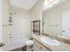 Bathroom with a shower-tub, and a vanity with stone countertop at 558 E Dry Creek Pl, Littleton, CO 80122