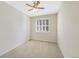 Bright bedroom featuring neutral walls, ceiling fan and carpeted floors at 558 E Dry Creek Pl, Littleton, CO 80122