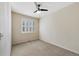 Bright bedroom featuring neutral walls, ceiling fan and carpeted floors at 558 E Dry Creek Pl, Littleton, CO 80122