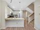 Modern kitchen featuring stainless steel appliances, granite countertops and convenient breakfast bar at 558 E Dry Creek Pl, Littleton, CO 80122
