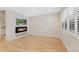 Bright living room with hardwood floors, modern fireplace and natural light from the windows at 558 E Dry Creek Pl, Littleton, CO 80122