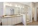 Elegant main bathroom with double sinks, granite countertops, and a glass-enclosed shower at 558 E Dry Creek Pl, Littleton, CO 80122