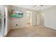 Spacious main bedroom with TV, plush carpet and a view of the bathroom at 558 E Dry Creek Pl, Littleton, CO 80122