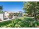 Expansive backyard featuring a green lawn, mature trees, a patio, and a screened-in porch at 11279 E Alaska Pl, Aurora, CO 80012