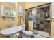 Updated bathroom with a tiled shower, modern fixtures, and ample natural light at 11279 E Alaska Pl, Aurora, CO 80012