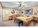 Well-lit bedroom with neutral tones, featuring a wooden bed frame and ample natural light at 11279 E Alaska Pl, Aurora, CO 80012