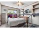 Cozy bedroom featuring a ceiling fan, window, and space for a treadmill at 11279 E Alaska Pl, Aurora, CO 80012