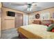 Comfortable bedroom with a ceiling fan, closet space, and natural light from the window at 11279 E Alaska Pl, Aurora, CO 80012