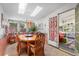 Bright dining room with skylights, wooden table, and a seamless transition to living room at 11279 E Alaska Pl, Aurora, CO 80012