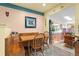 Cozy dining area with wooden table, built-in seating, and a view into the living room at 11279 E Alaska Pl, Aurora, CO 80012