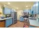 Cozy kitchen with stainless steel appliances, blue cabinets, and modern fixtures at 11279 E Alaska Pl, Aurora, CO 80012