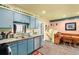 Cozy kitchen with stainless steel appliances, blue cabinets, and an adjacent dining area at 11279 E Alaska Pl, Aurora, CO 80012