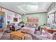 Bright living room featuring a skylight, comfortable seating, and a welcoming atmosphere at 11279 E Alaska Pl, Aurora, CO 80012