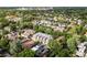 The aerial shot captures a housing complex nestled amidst lush greenery within a vibrant city at 425 Steele St, Denver, CO 80206
