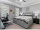 Neutral bedroom with a tray ceiling, carpeted floors, with a desk and nightstands at 425 Steele St, Denver, CO 80206