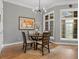 Dining area boasts hardwood floors, modern chandelier, and large windows at 425 Steele St, Denver, CO 80206